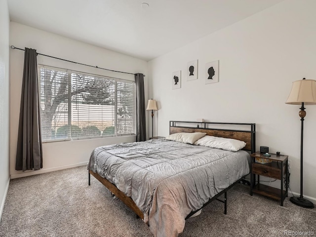 carpeted bedroom featuring baseboards