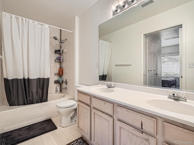 ensuite bathroom with double vanity, visible vents, shower / bath combination with curtain, and a sink