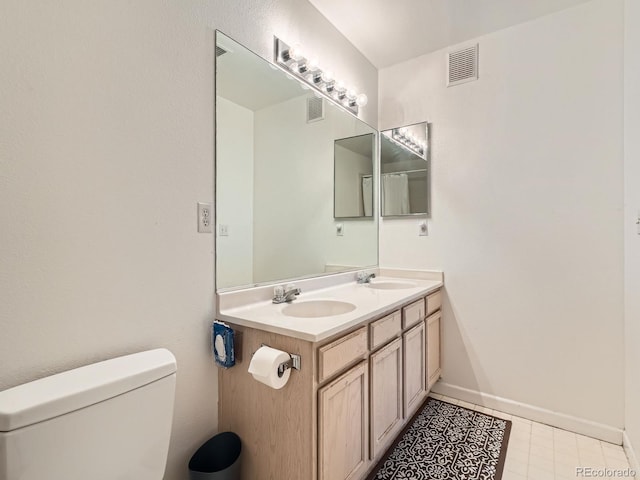 full bathroom with a sink, visible vents, and toilet