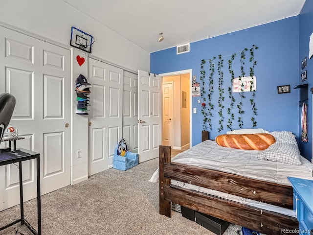 bedroom featuring visible vents, carpet floors, and a closet