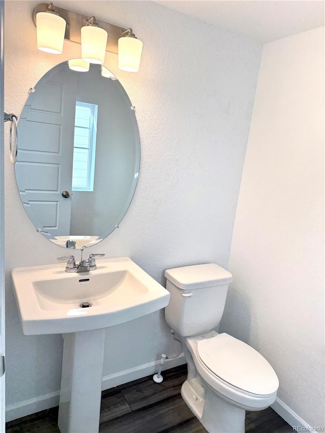 bathroom featuring hardwood / wood-style floors, sink, and toilet