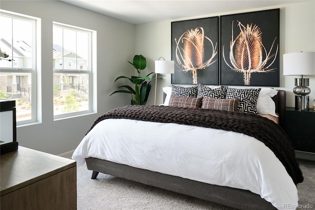 carpeted bedroom featuring multiple windows