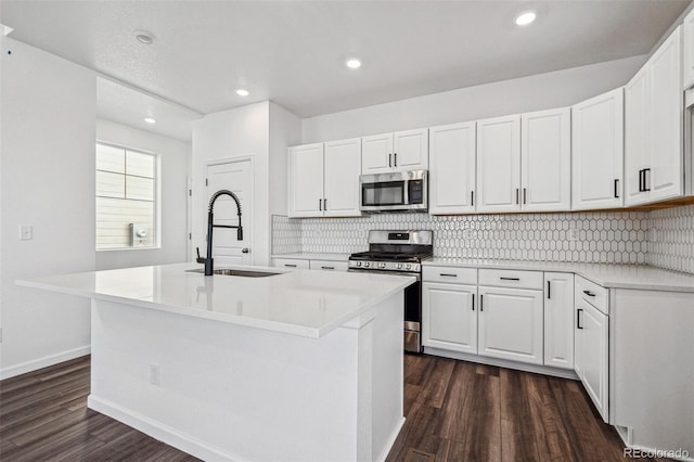 3282 N Catawba Way, Aurora, CO 80019 - kitchen with stainless steel appliances, a kitchen island with sink, and sink