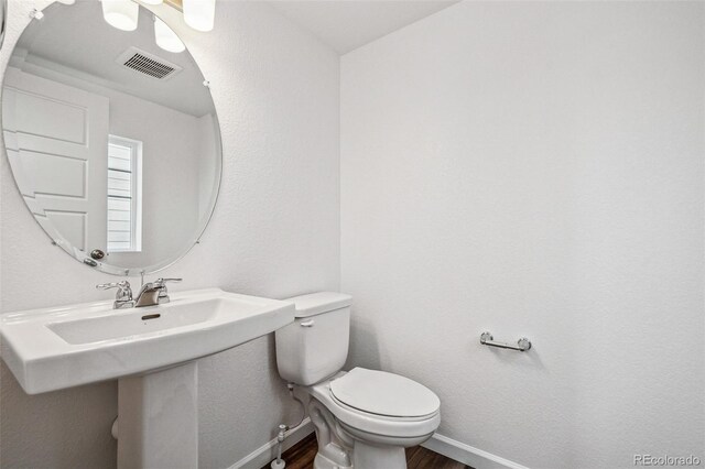 3282 N Catawba Way, Aurora, CO 80019 - bathroom with wood-type flooring and toilet