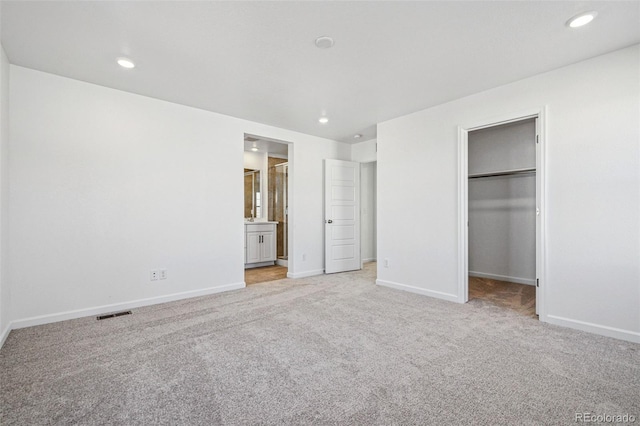 3282 N Catawba Way, Aurora, CO 80019 - unfurnished bedroom featuring a spacious closet, light colored carpet, a closet, and ensuite bathroom
