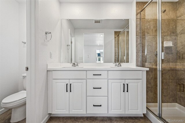 3282 N Catawba Way, Aurora, CO 80019 - bathroom featuring vanity, walk in shower, and toilet