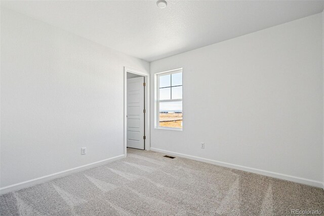 3282 N Catawba Way, Aurora, CO 80019 - spare room with light colored carpet and a textured ceiling