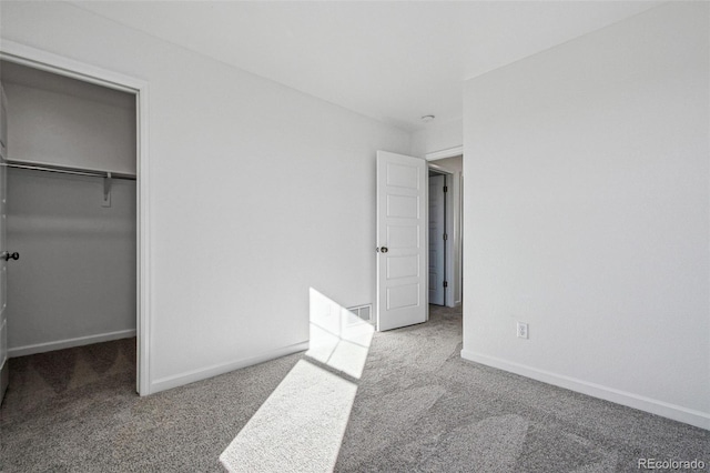 3282 N Catawba Way, Aurora, CO 80019 - unfurnished bedroom featuring a walk in closet, carpet, and a closet