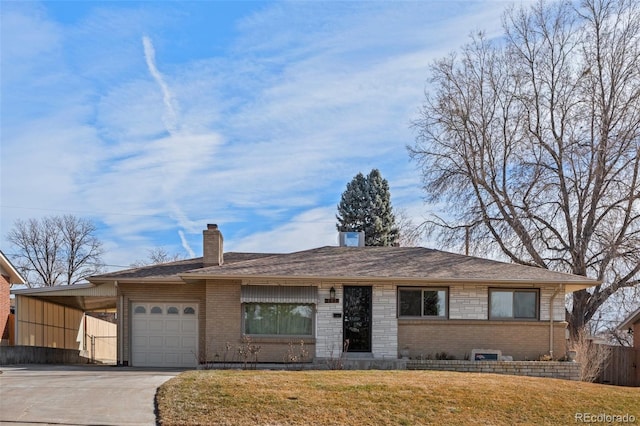 single story home with a garage, a front lawn, and a carport