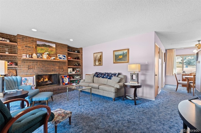 carpeted living room featuring ceiling fan, a textured ceiling, and a fireplace