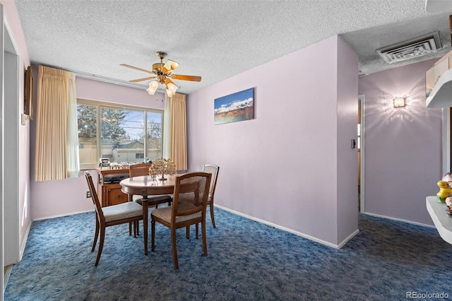 carpeted dining room with ceiling fan and a textured ceiling