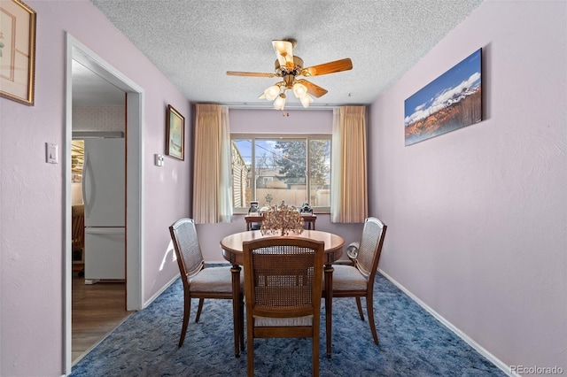 dining room with ceiling fan and a textured ceiling