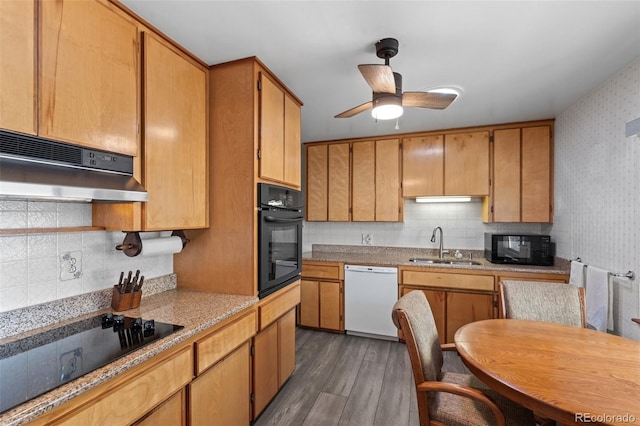 kitchen with tasteful backsplash, sink, dark hardwood / wood-style flooring, ceiling fan, and black appliances