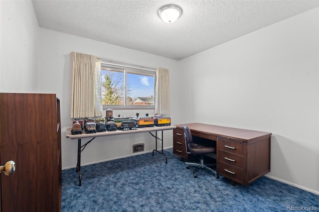 carpeted office with a textured ceiling