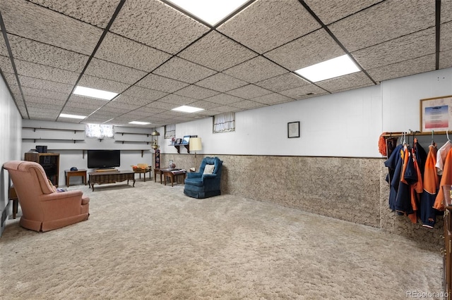 interior space with a drop ceiling and carpet floors