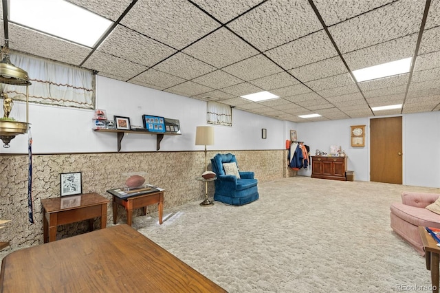 interior space with carpet floors and a drop ceiling