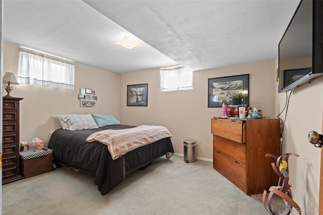 bedroom featuring multiple windows and light carpet