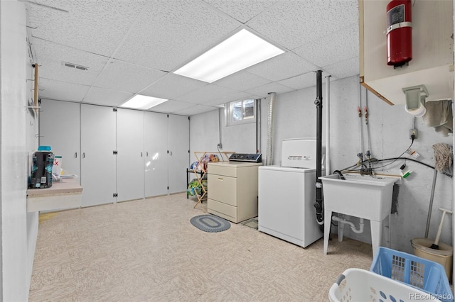 clothes washing area featuring washer and clothes dryer