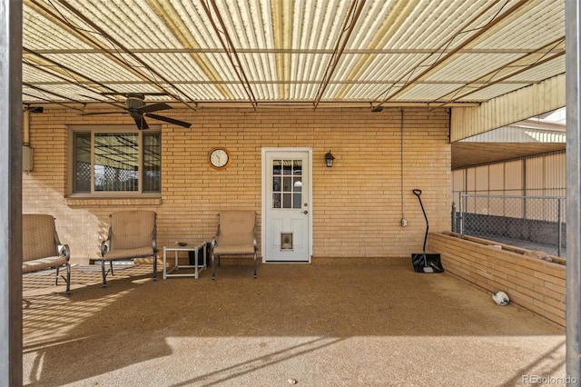 view of exterior entry featuring a patio area and ceiling fan