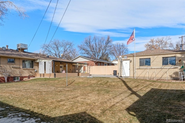 rear view of house with a yard