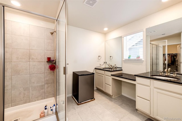 full bathroom with a stall shower, recessed lighting, visible vents, and vanity