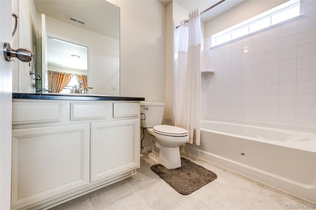 full bathroom with shower / tub combo with curtain, visible vents, toilet, vanity, and tile patterned floors