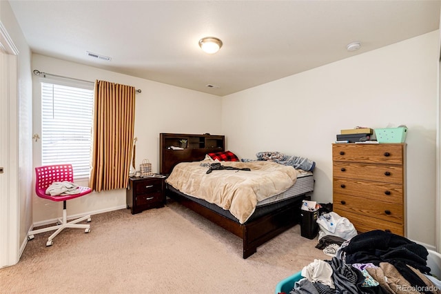 bedroom with light carpet, baseboards, and visible vents