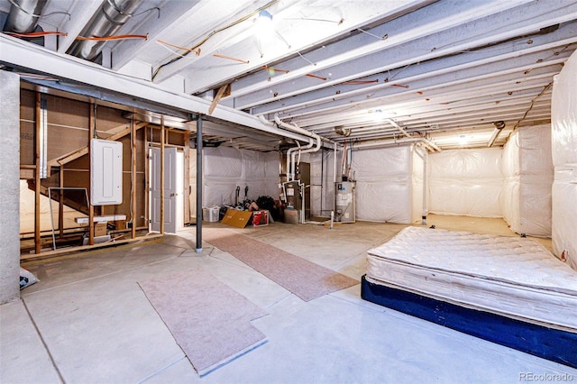 unfinished basement with gas water heater and heating unit