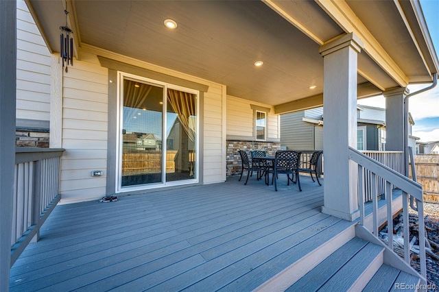 wooden terrace with outdoor dining space