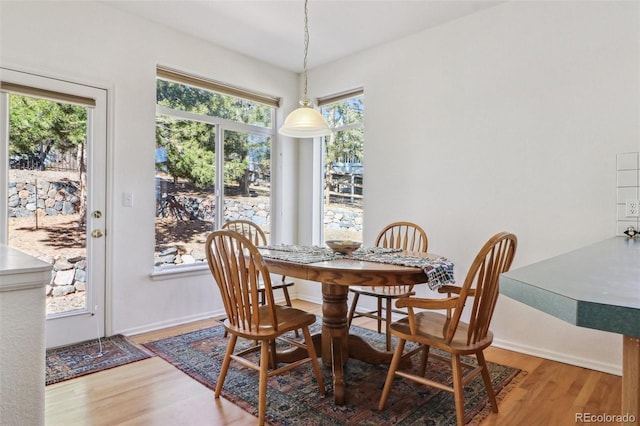 dining area featuring wood finished floors and baseboards