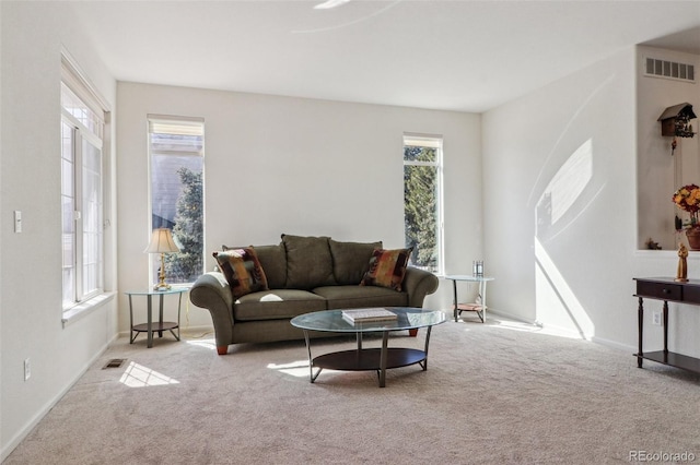 carpeted living room featuring visible vents