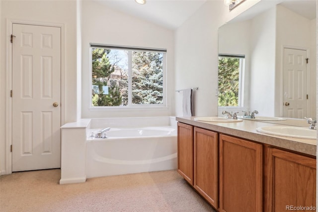 bathroom with lofted ceiling, carpet flooring, a sink, and a healthy amount of sunlight