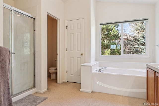 bathroom with toilet, a stall shower, a garden tub, and vanity