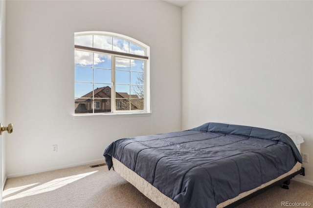 bedroom featuring carpet floors, visible vents, and baseboards