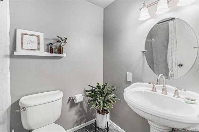 6731 Devinney St, Arvada, CO 80004 - bathroom with a sink, toilet, and baseboards