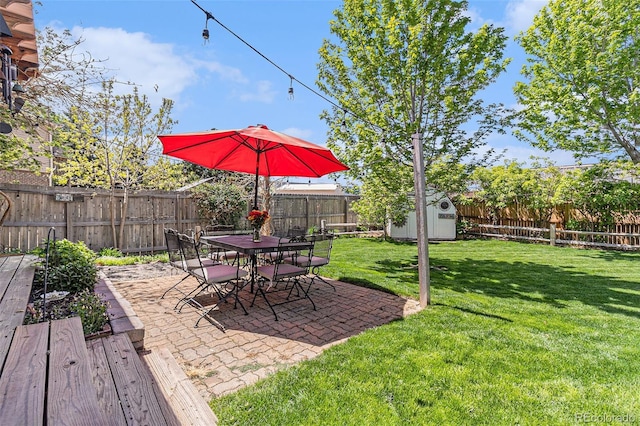 6731 Devinney St, Arvada, CO 80004 - view of yard featuring a storage shed, an outdoor structure, a patio, and outdoor dining space