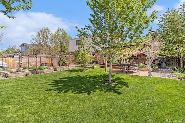 6731 Devinney St, Arvada, CO 80004 - view of yard featuring a vegetable garden and a patio area