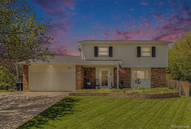6731 Devinney St, Arvada, CO 80004 - traditional-style house featuring driveway, an attached garage, and brick siding