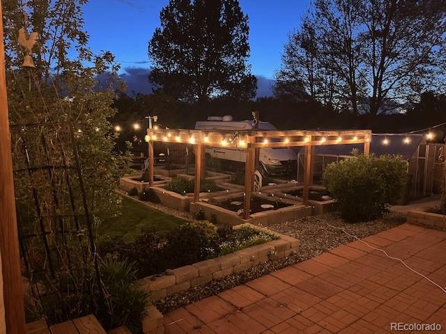 6731 Devinney St, Arvada, CO 80004 - view of yard with a vegetable garden and a patio