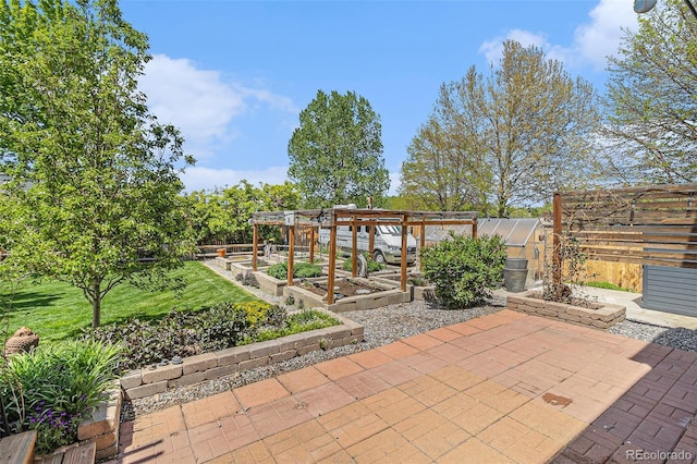 6731 Devinney St, Arvada, CO 80004 - view of patio / terrace featuring an exterior structure, a vegetable garden, and an outbuilding