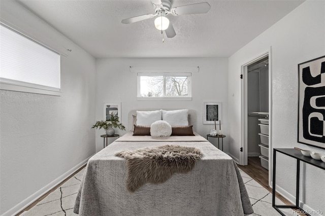 6133 S Sterne Cir, Littleton, CO 80120 - bedroom featuring baseboards, a ceiling fan, and a textured ceiling