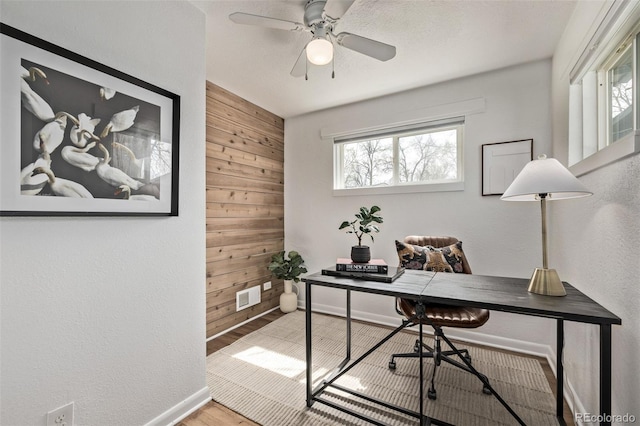 6133 S Sterne Cir, Littleton, CO 80120 - office area featuring wooden walls, baseboards, visible vents, and plenty of natural light