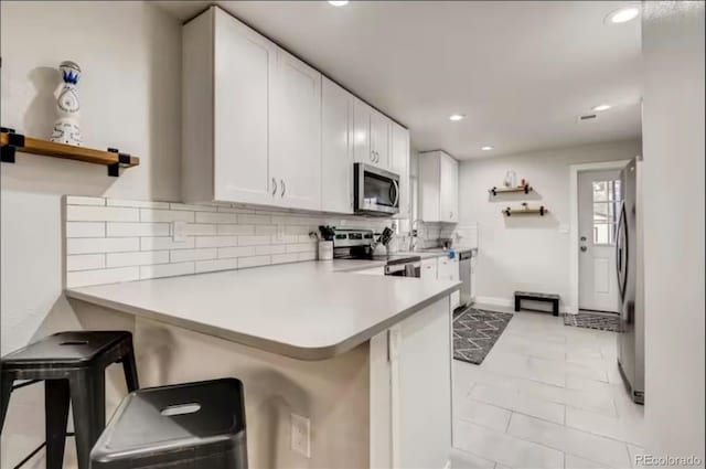150 S Osceola St, Denver, CO 80219 - kitchen featuring stainless steel appliances, backsplash, light countertops, open shelves, and recessed lighting