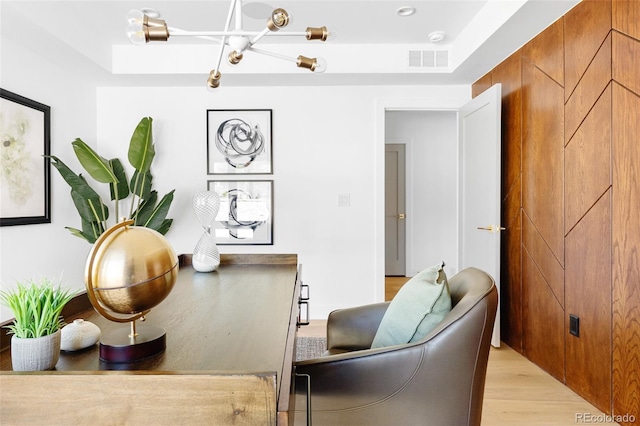 dining area featuring light wood-style flooring and a chandelier