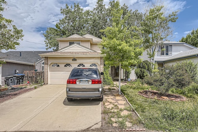 2370 Redwood Ave, Lafayette, CO 80026 - view of front facade with concrete driveway, an attached garage, and brick siding