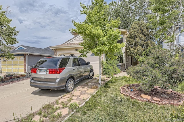 2370 Redwood Ave, Lafayette, CO 80026 - view of side of property with concrete driveway, an attached garage, and brick siding