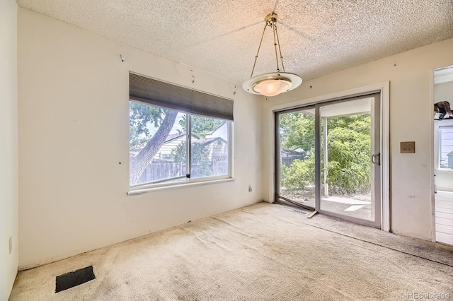 2370 Redwood Ave, Lafayette, CO 80026 - unfurnished dining area with carpet floors and a textured ceiling