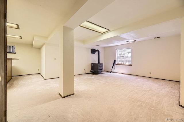 2370 Redwood Ave, Lafayette, CO 80026 - basement featuring a wood stove and light carpet