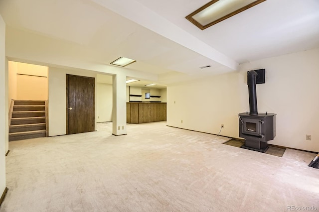 2370 Redwood Ave, Lafayette, CO 80026 - unfurnished living room with stairway, a wood stove, and carpet