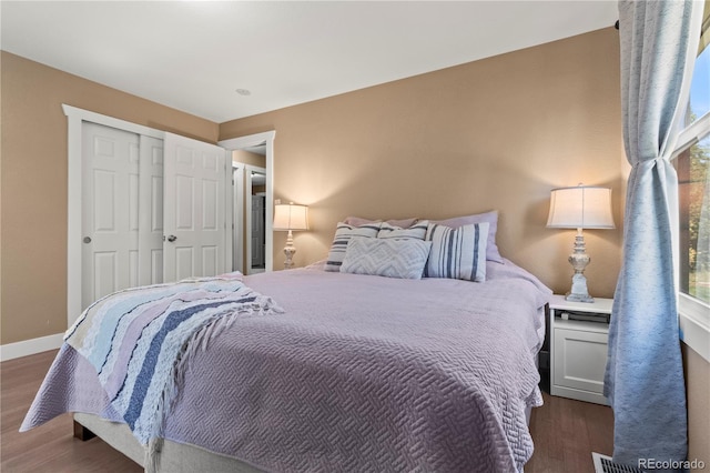 bedroom featuring dark hardwood / wood-style flooring and a closet